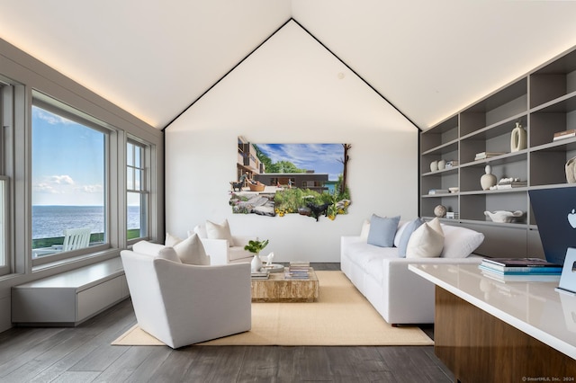 sitting room featuring lofted ceiling, a water view, and wood finished floors