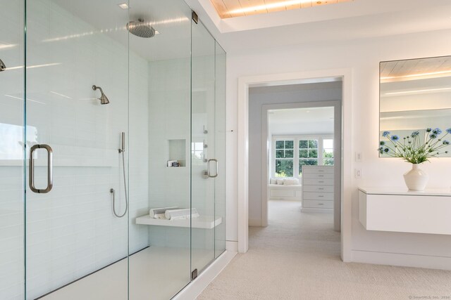 bathroom with a shower with door