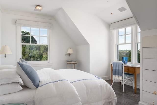 bedroom with dark wood-style floors, multiple windows, lofted ceiling, and visible vents