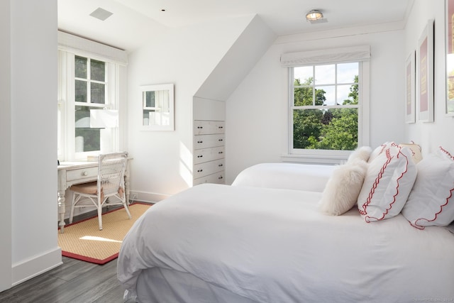 bedroom featuring visible vents, baseboards, and wood finished floors