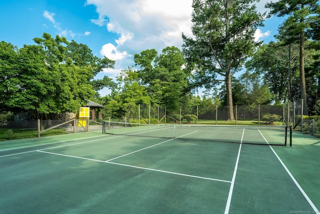 view of sport court featuring fence