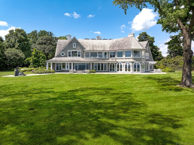 back of house with a lawn