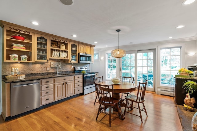 kitchen with a baseboard radiator, appliances with stainless steel finishes, sink, and light wood-type flooring