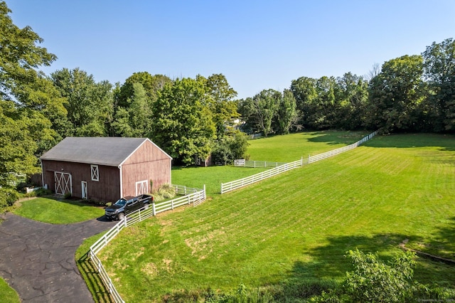 view of yard with an outdoor structure and a rural view