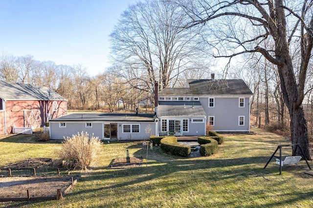 rear view of house with a lawn