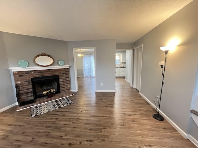 living room featuring hardwood / wood-style floors and a brick fireplace