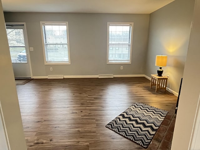 spare room with dark hardwood / wood-style floors