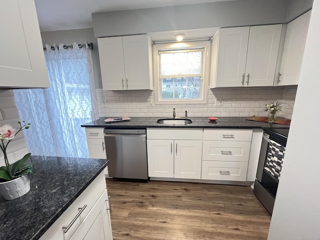 kitchen featuring stainless steel appliances, white cabinetry, and sink