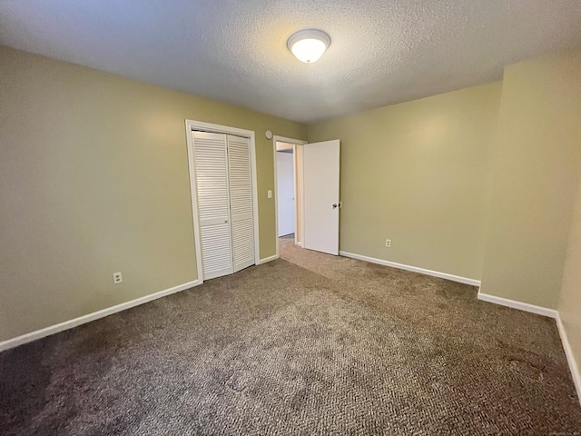 unfurnished bedroom with a closet, carpet, and a textured ceiling