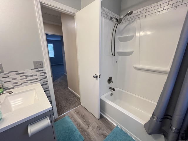 bathroom featuring decorative backsplash, vanity, hardwood / wood-style flooring, and shower / bathtub combination with curtain