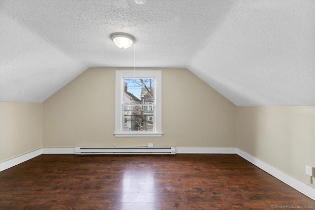 bonus room featuring a textured ceiling, lofted ceiling, dark wood-type flooring, and a baseboard heating unit