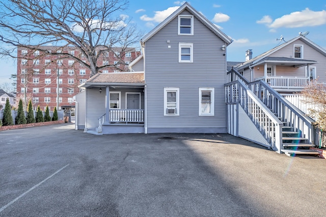 back of property with a porch