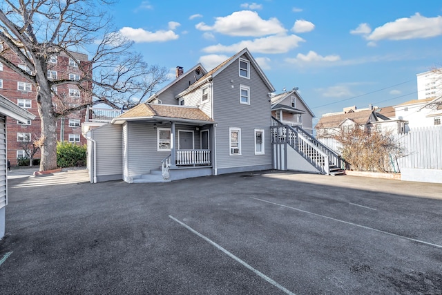 back of property with a porch