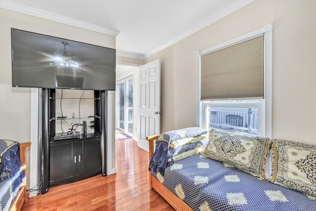 bedroom featuring wood-type flooring and crown molding