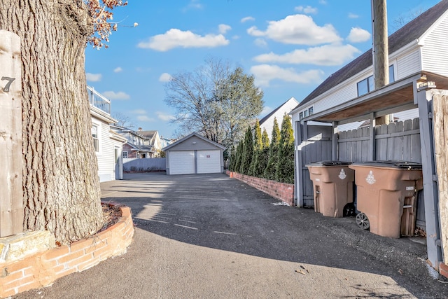 view of property exterior with an outdoor structure and a garage