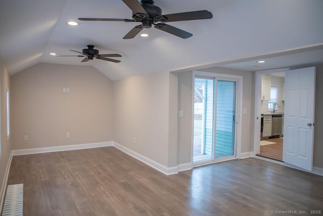 bonus room featuring hardwood / wood-style floors, ceiling fan, lofted ceiling, and sink