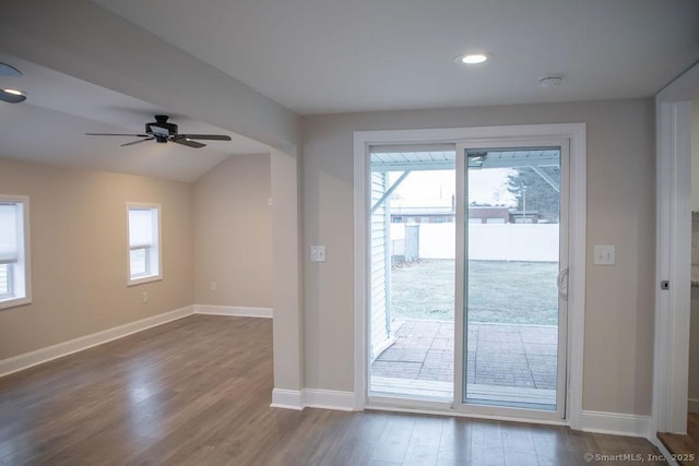 entryway featuring vaulted ceiling, ceiling fan, a healthy amount of sunlight, and dark hardwood / wood-style floors