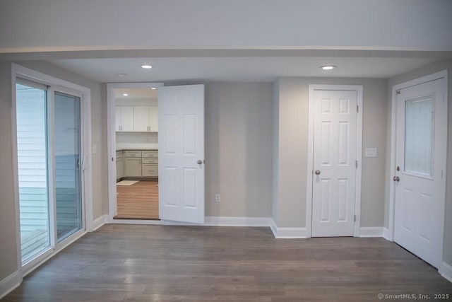 unfurnished room with wood-type flooring