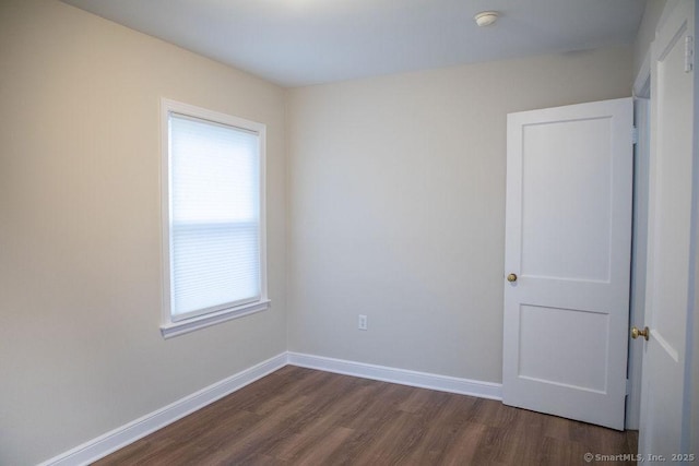 spare room with dark hardwood / wood-style flooring