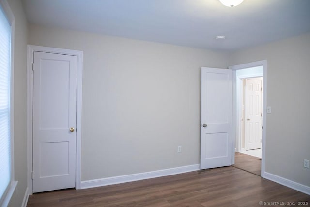 empty room featuring dark wood-type flooring