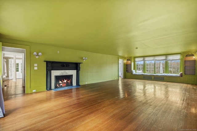 unfurnished living room with a fireplace and hardwood / wood-style floors