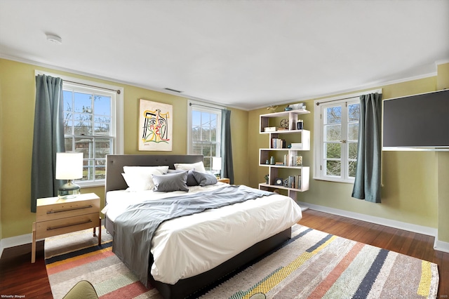 bedroom featuring hardwood / wood-style flooring and ornamental molding