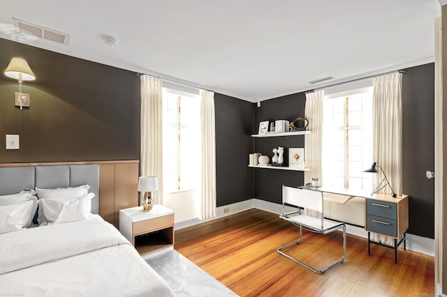 bedroom featuring multiple windows and hardwood / wood-style floors