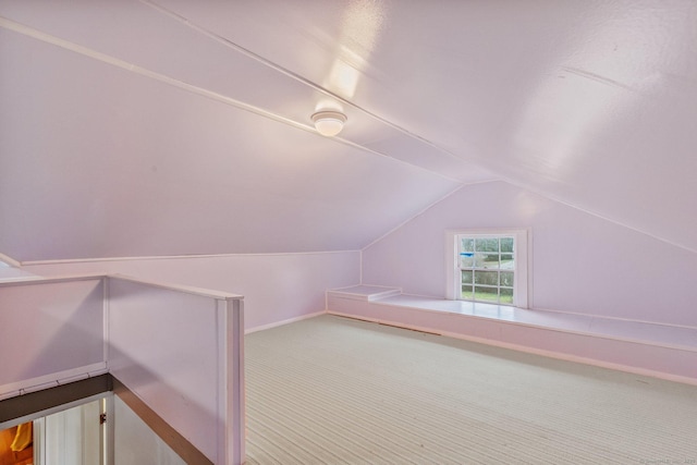 bonus room featuring vaulted ceiling and carpet flooring