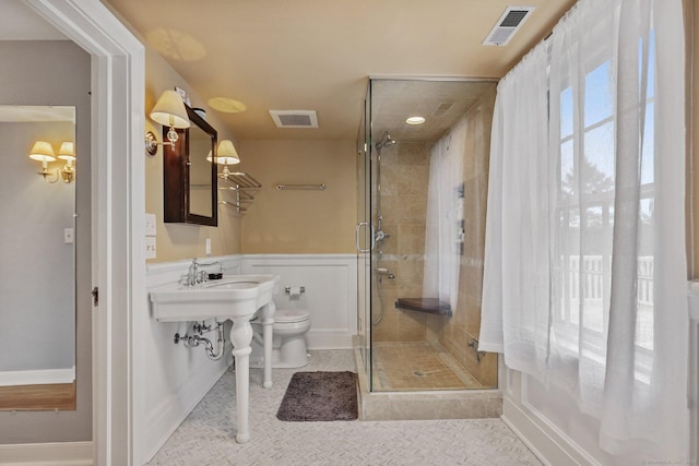 bathroom with an enclosed shower, tile patterned floors, and toilet