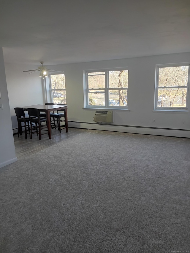 dining area with ceiling fan and a baseboard heating unit