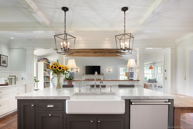 kitchen featuring dishwasher, open floor plan, a sink, ornate columns, and beam ceiling