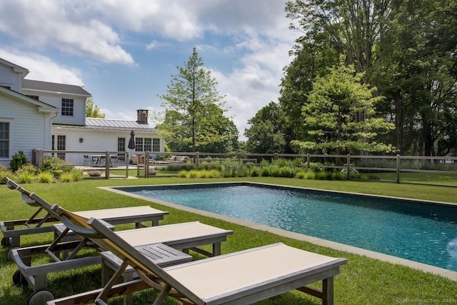 view of swimming pool with fence, a fenced in pool, and a yard