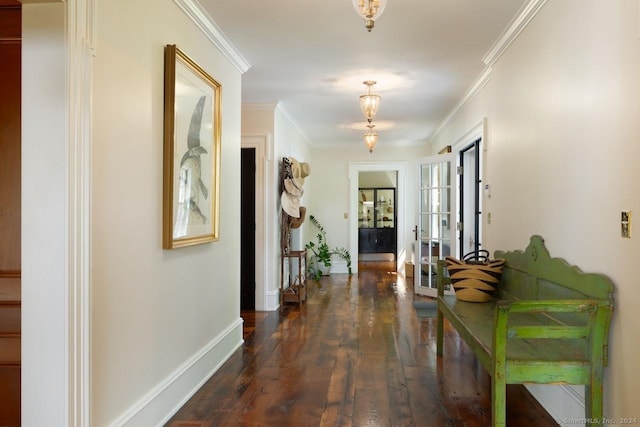 corridor with french doors, ornamental molding, wood finished floors, and baseboards