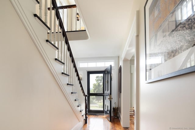 entrance foyer featuring stairs and wood finished floors