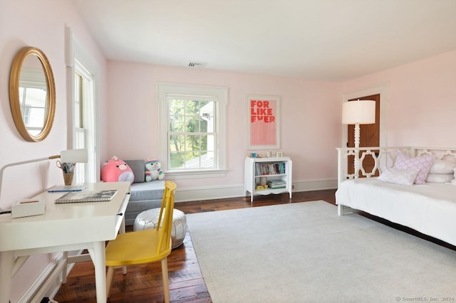 bedroom featuring wood finished floors, visible vents, and baseboards