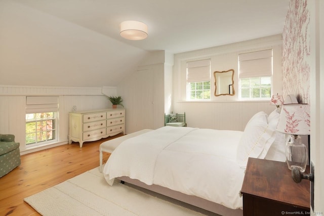 bedroom featuring vaulted ceiling and wood finished floors