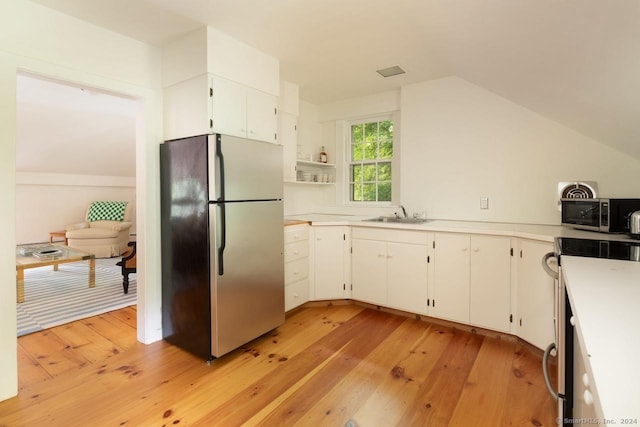 kitchen featuring light wood-type flooring, open shelves, white cabinets, and stainless steel appliances