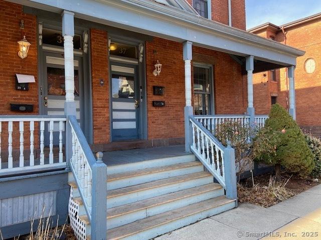 view of exterior entry with covered porch