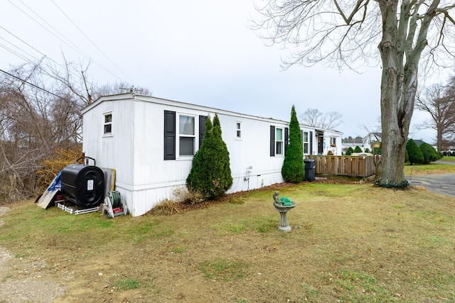 view of property exterior with a lawn