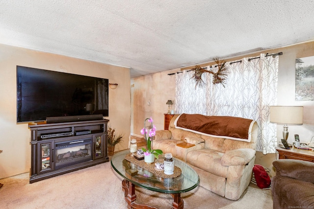 living room featuring a textured ceiling, a glass covered fireplace, and carpet flooring