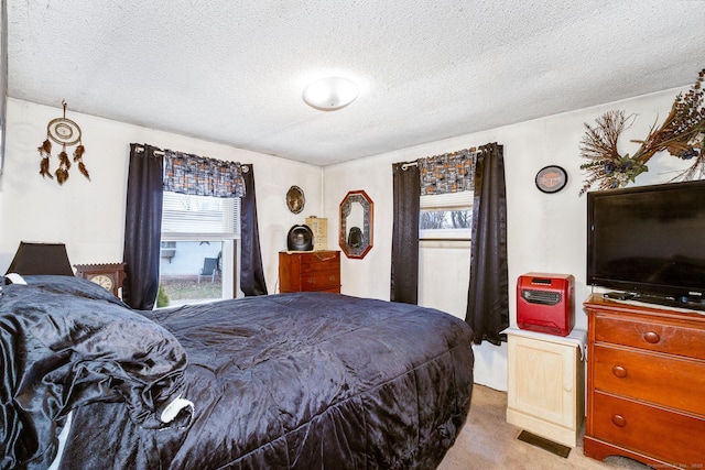 carpeted bedroom featuring a textured ceiling