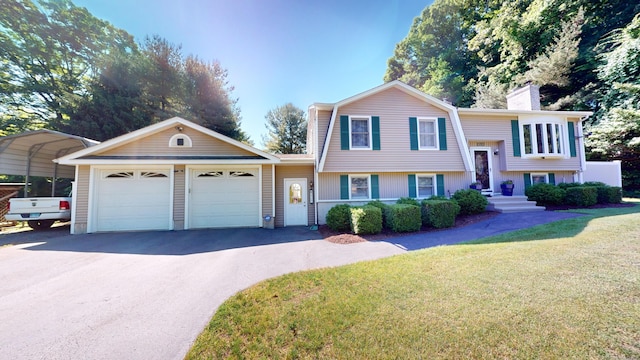 view of front of house featuring a front yard, a garage, and a carport