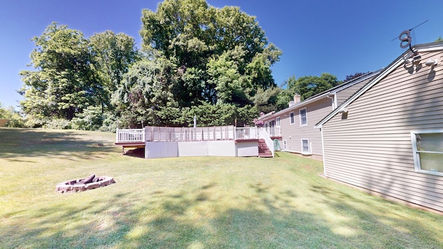 view of yard with a fire pit and a deck