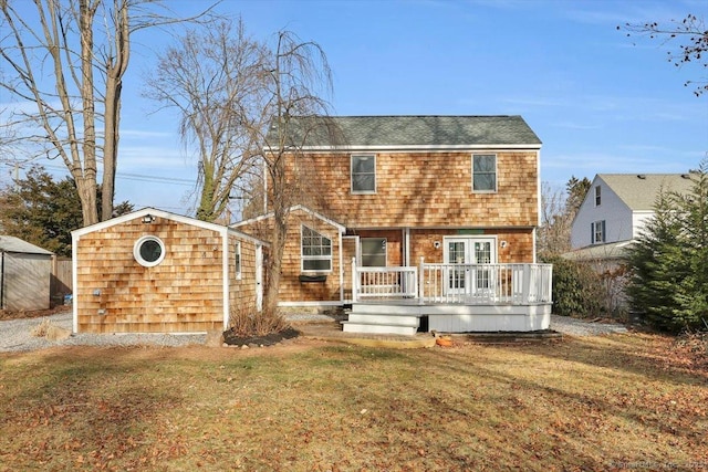 rear view of property with a lawn and a wooden deck