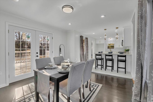 dining room featuring ornamental molding, french doors, and dark hardwood / wood-style flooring