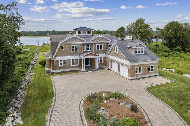 view of front of house with a water view and a front yard