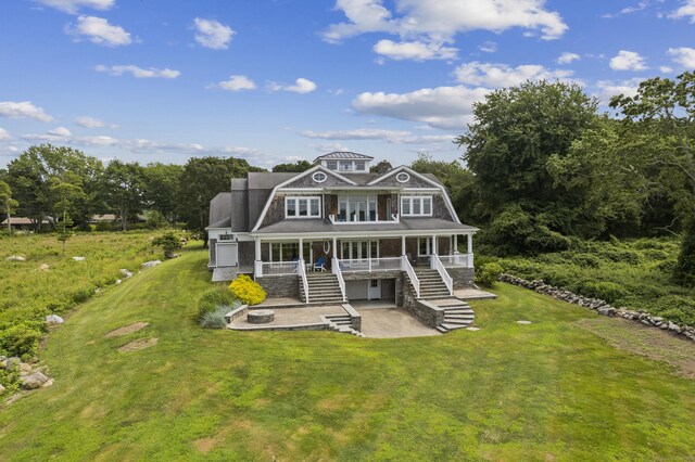 view of front facade with covered porch and a front yard