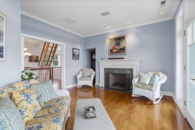 living room with crown molding and hardwood / wood-style floors