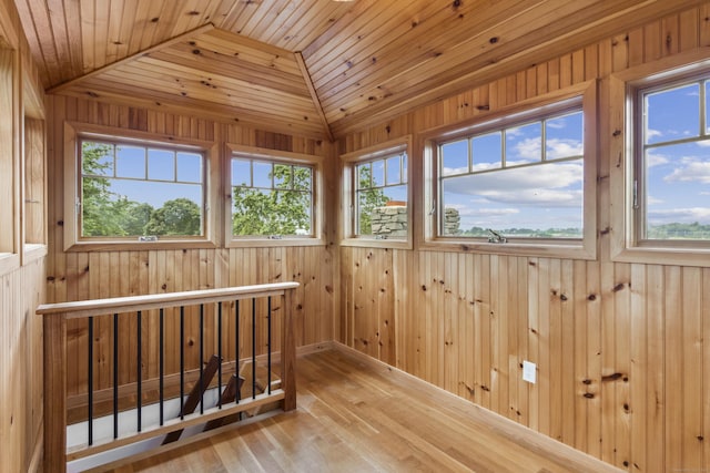 unfurnished sunroom featuring lofted ceiling and wooden ceiling