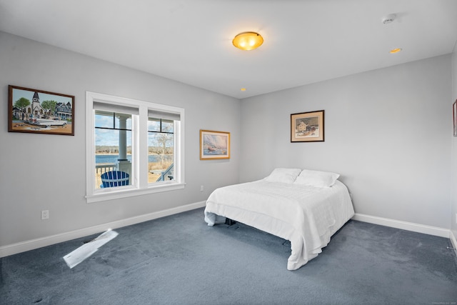 bedroom featuring baseboards and dark colored carpet